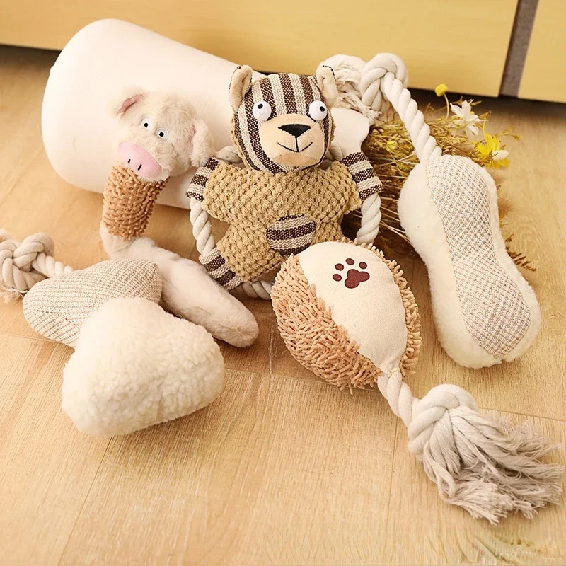 A set of cotton rope and plush chew toys, including a striped bear and pig, designed for dogs to chew, tug, and cuddle.